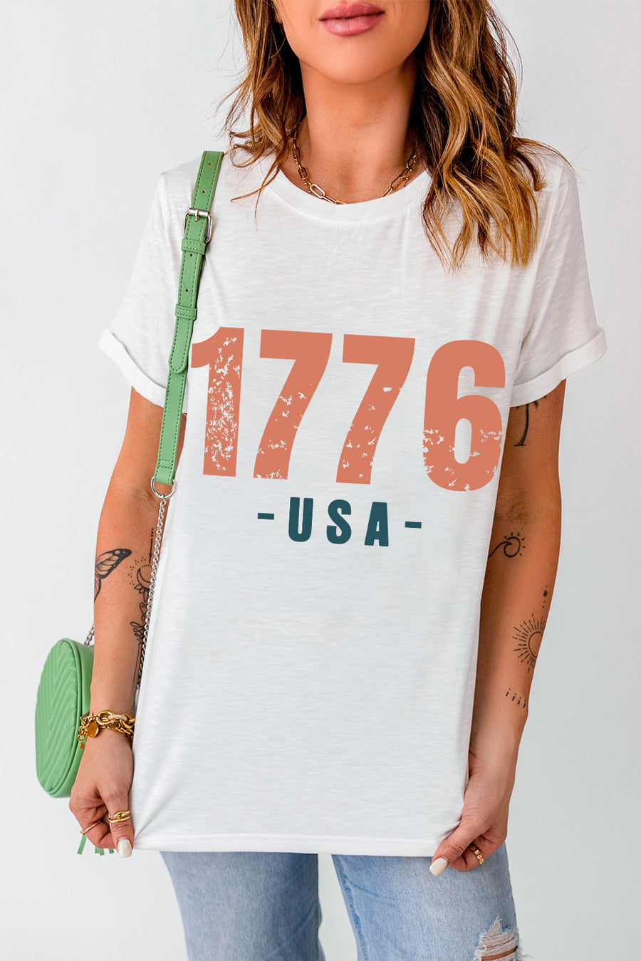 White t-shirt with distressed 1776 USA graphic, crew neck, short sleeves.