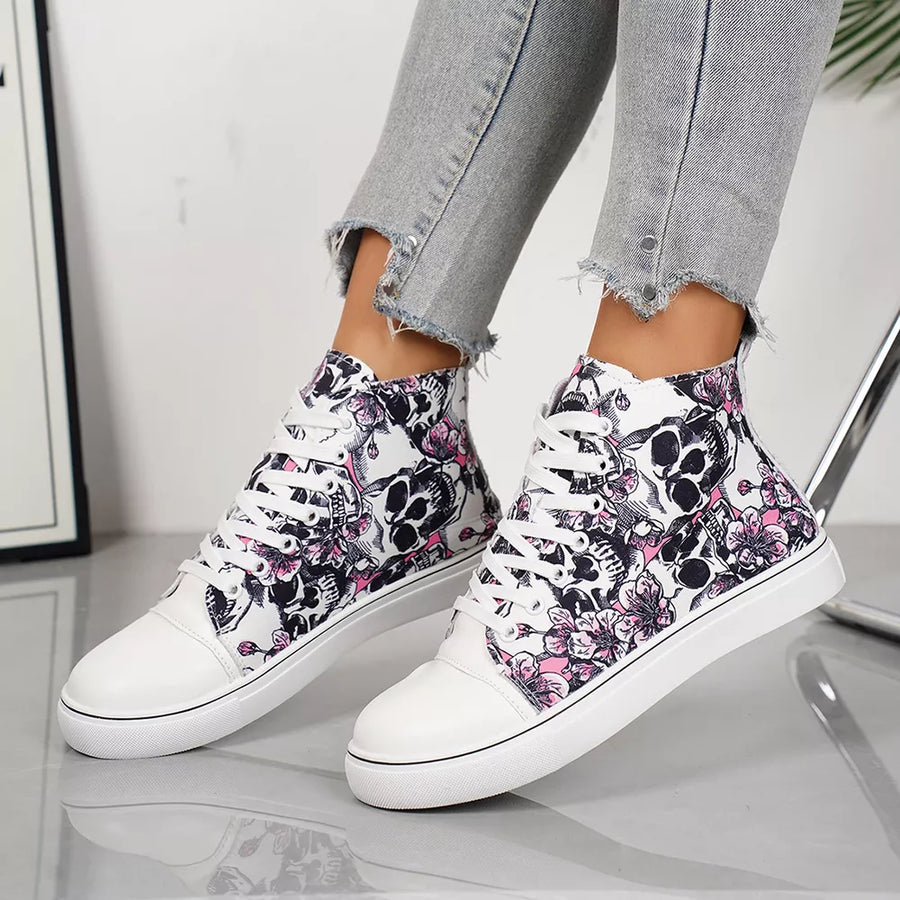White lace-up sneakers with a black and pink floral skull print.