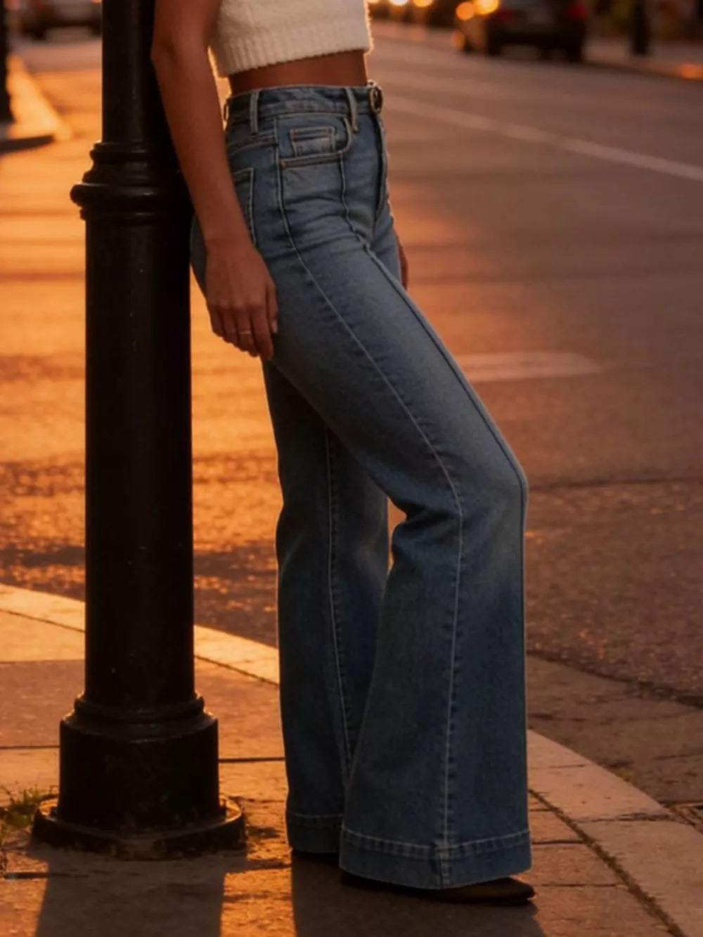 High-waisted flare jeans in light wash denim with button closure and wide leg.
