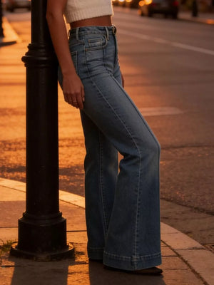 High-waisted flare jeans in light wash denim with button closure and wide leg.