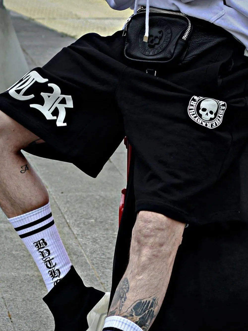 Black Gothic Script Graphic Shorts with skull patch and white gothic lettering.