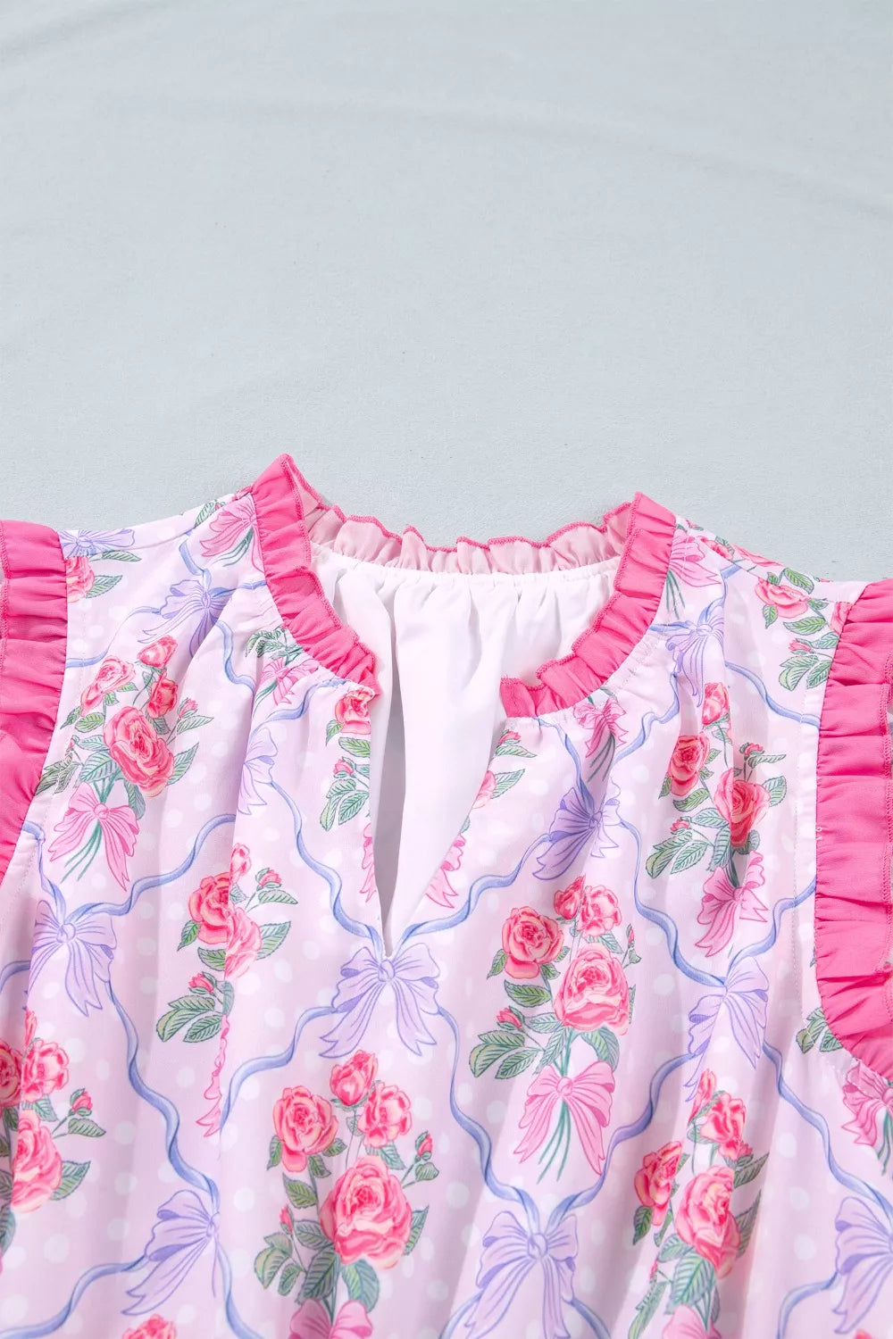 Women's pink floral dress with ruffled neckline and sleeves, bow and polka dot print