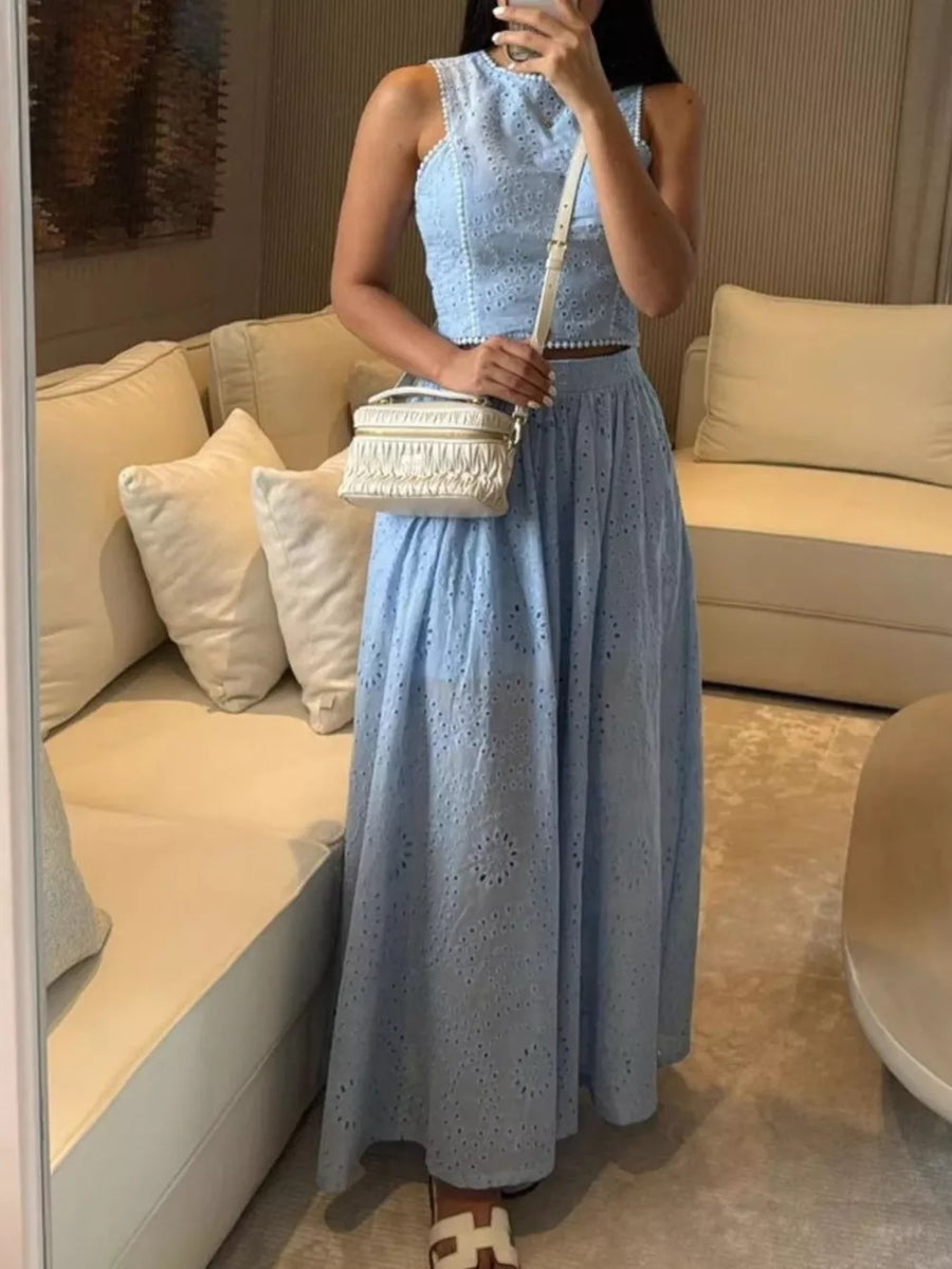 Light blue eyelet cropped top and maxi skirt set with a white crossbody bag.