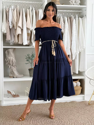 Navy off-the-shoulder smocked midi dress with tiered skirt and rope belt.