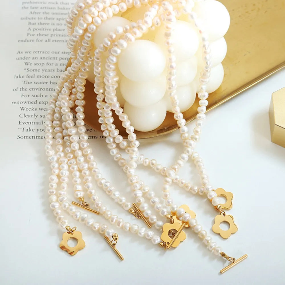 Freshwater pearl necklace with gold floral clasps and toggle closures