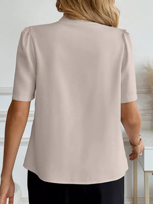 Apricot v-neck button-down shirt with puff sleeves and a relaxed fit.