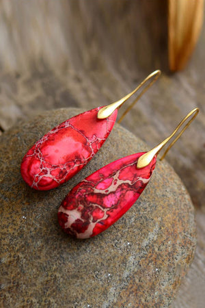 Red Ocean Jasper dangle earrings with gold hooks and natural stone patterns.