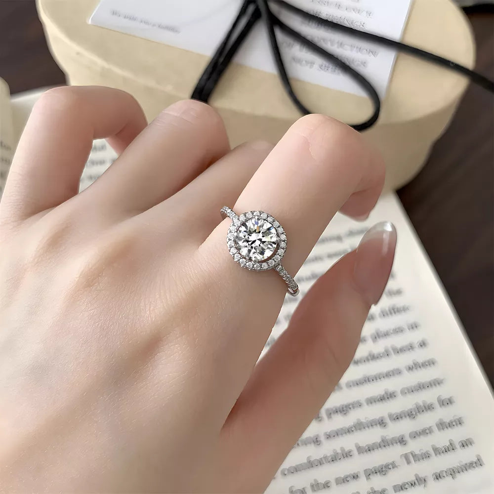 ring in silver featuring halo setting and round fit
