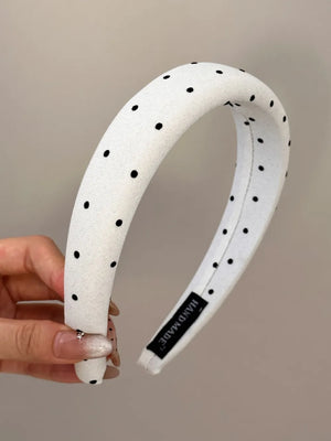 White padded headband with black polka dots and a handmade label