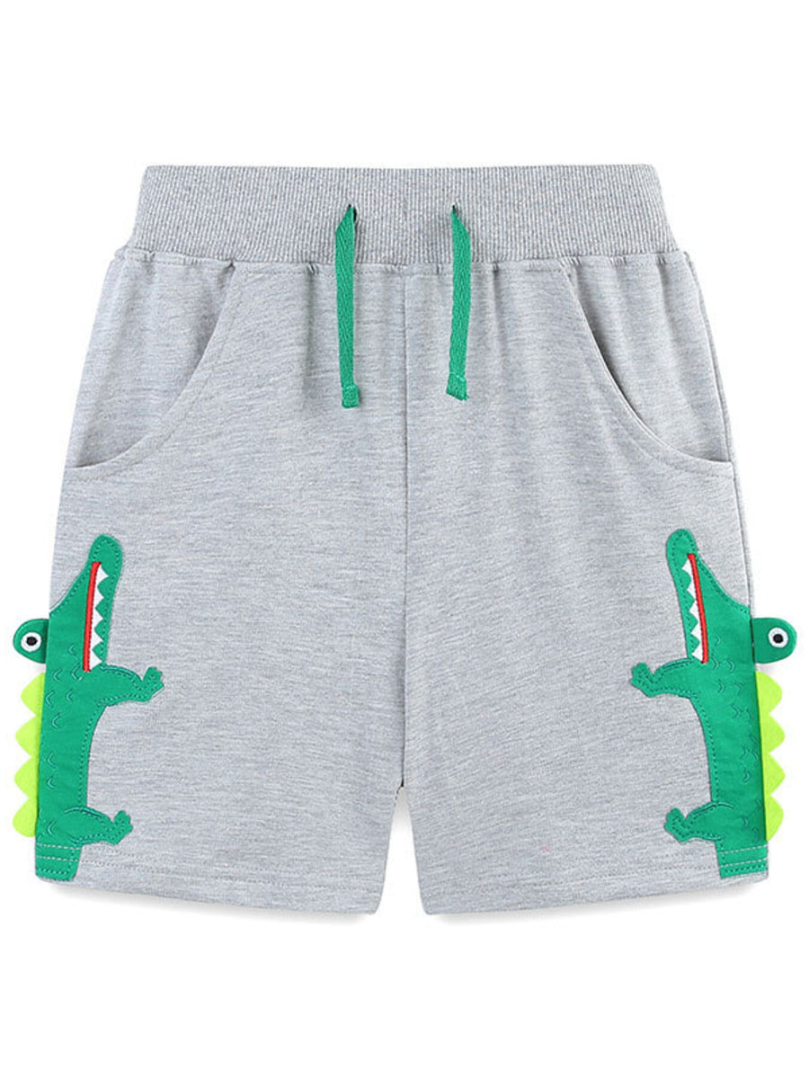 Grey cotton shorts with green alligator applique and drawstring.