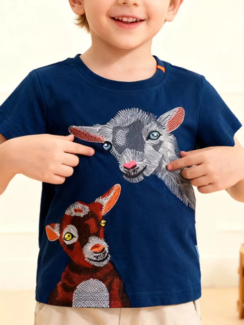 Navy blue toddler t-shirt with embroidered goat faces, short sleeves, crew neck.