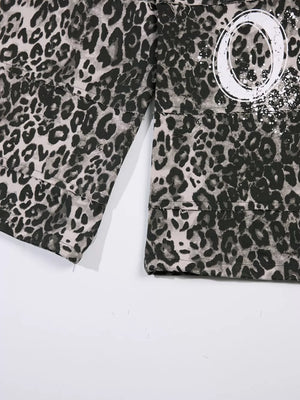 Leopard print cotton sweatpants with wide legs and a graphic detail.