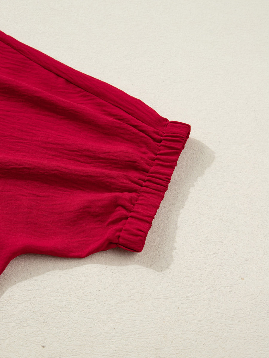 Deep red braided V-neck blouse with ruched half sleeves and crinkled texture.