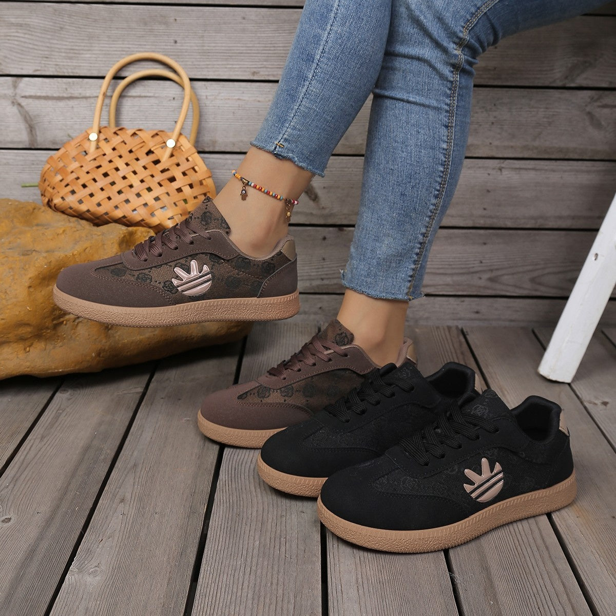 Round toe lace up sneakers in brown and black with all over pattern and tan sole.