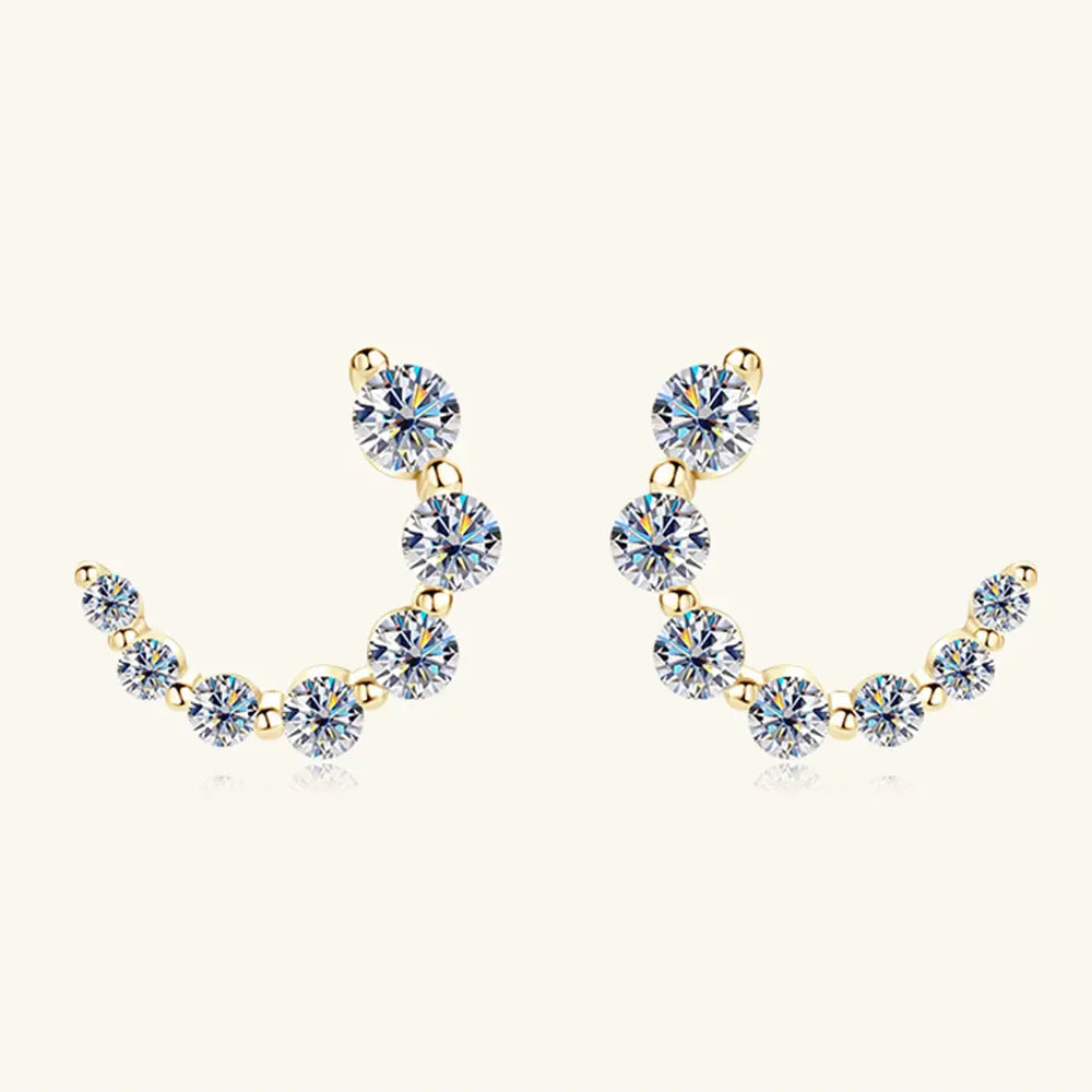 Gold Celestial Arc Moissanite Earrings with a curved row of sparkling stones and 18K gold plating.