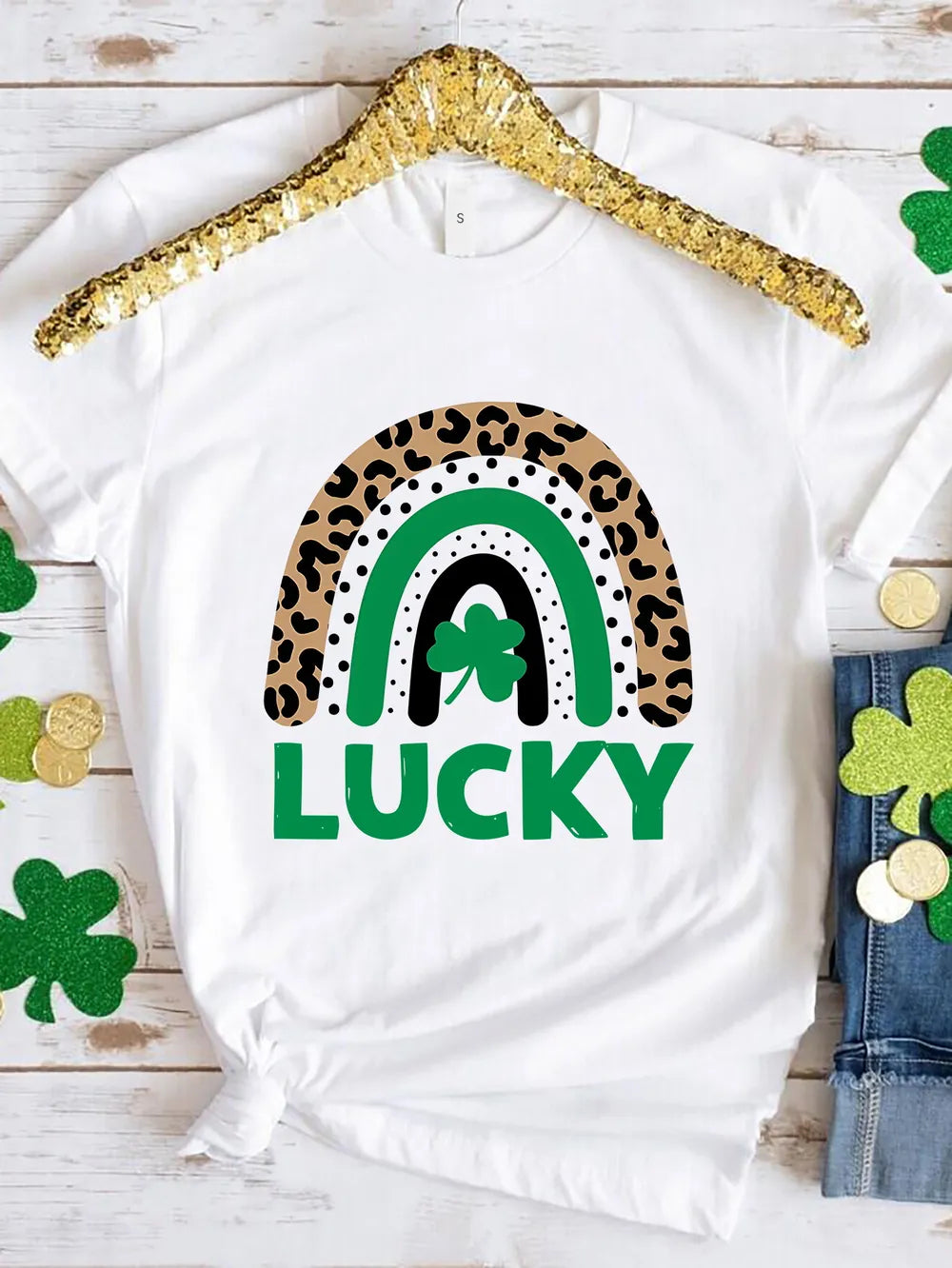 White t-shirt with a leopard print rainbow graphic and the word LUCKY.