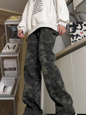 Relaxed fit cargo pants in green camouflage pattern with visible stitching details.
