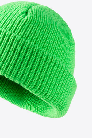 Ribbed knit beanie in bright green with a folded edge.