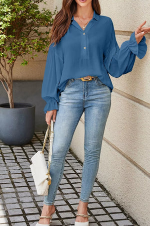 Blue peasant blouse with button front and ruffled bell sleeves, paired with light wash skinny jeans.