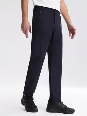 Navy blue sweatpants with zippered pockets and a straight leg fit.