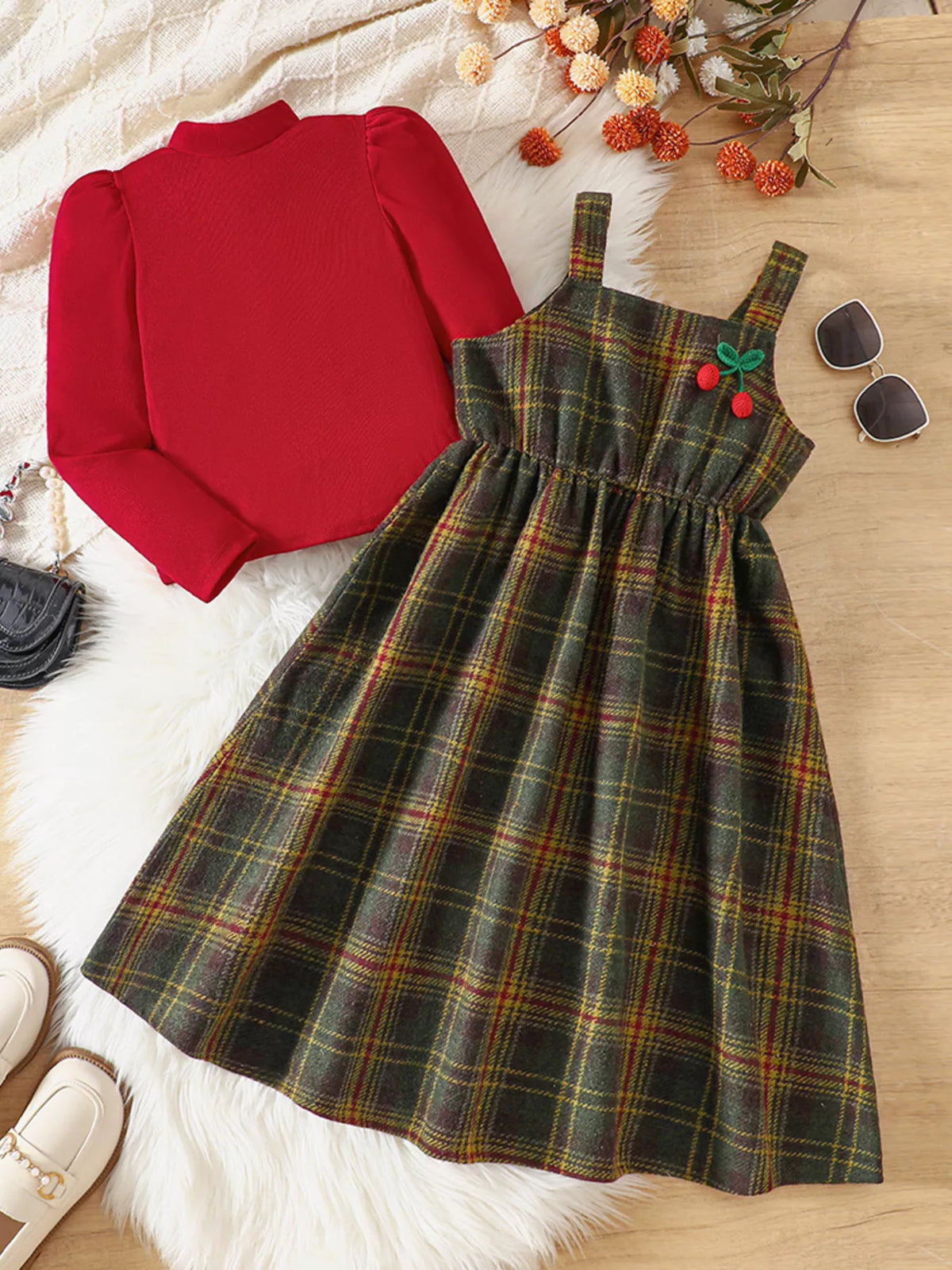 Girls' red long sleeve top and multicolor plaid dress set with cherry detail.