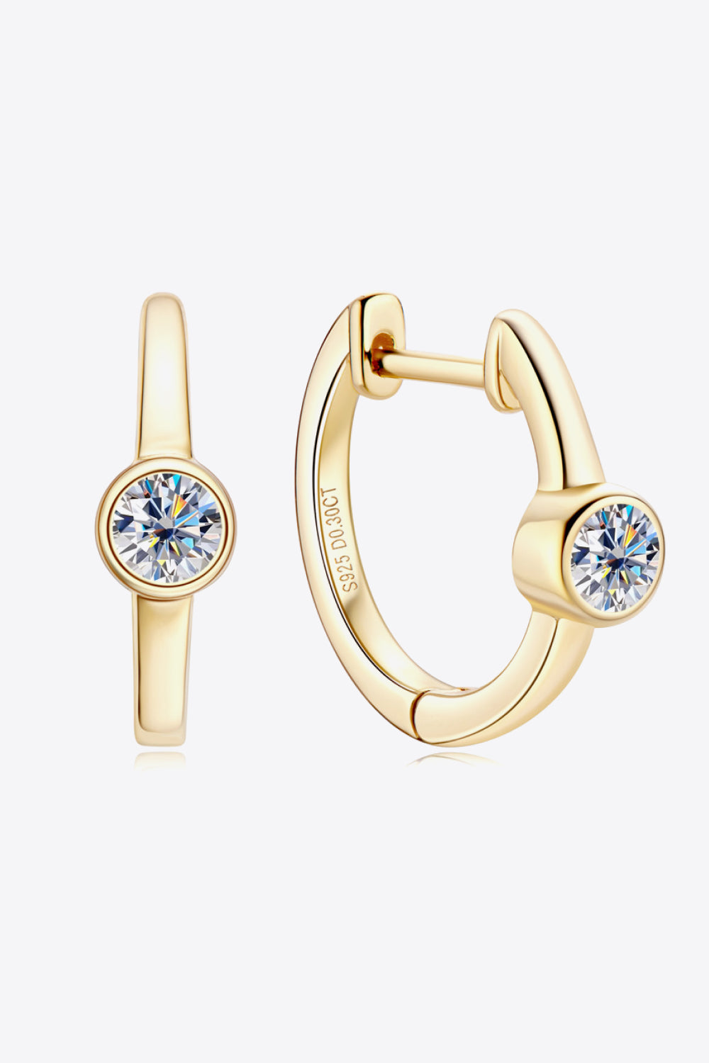 Gold bezel-set sparkle huggie hoop earrings with clear cubic zirconia stones.