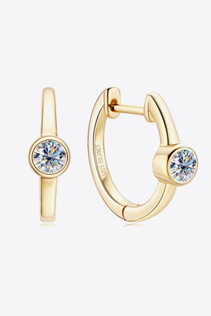 Gold bezel-set sparkle huggie hoop earrings with clear cubic zirconia stones.