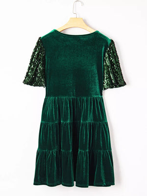 Dark green velvet tiered mini dress with sequin puff sleeves.