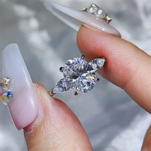 Platinum-plated, 925 sterling silver, Moissanite, Zircon (accent stones) Carat w ring in clear with three-stone oval with
