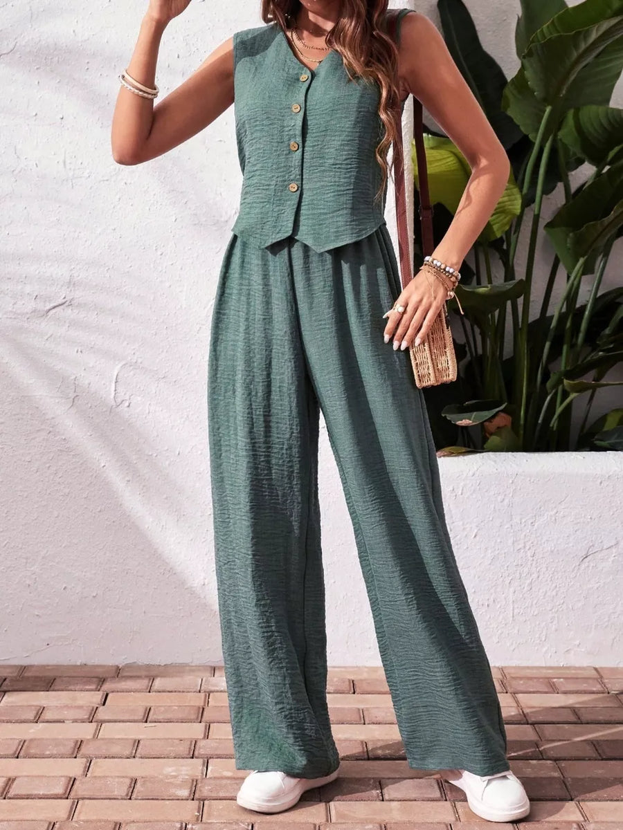 Turquoise buttoned cropped vest and wide-leg pants ensemble with textured fabric.