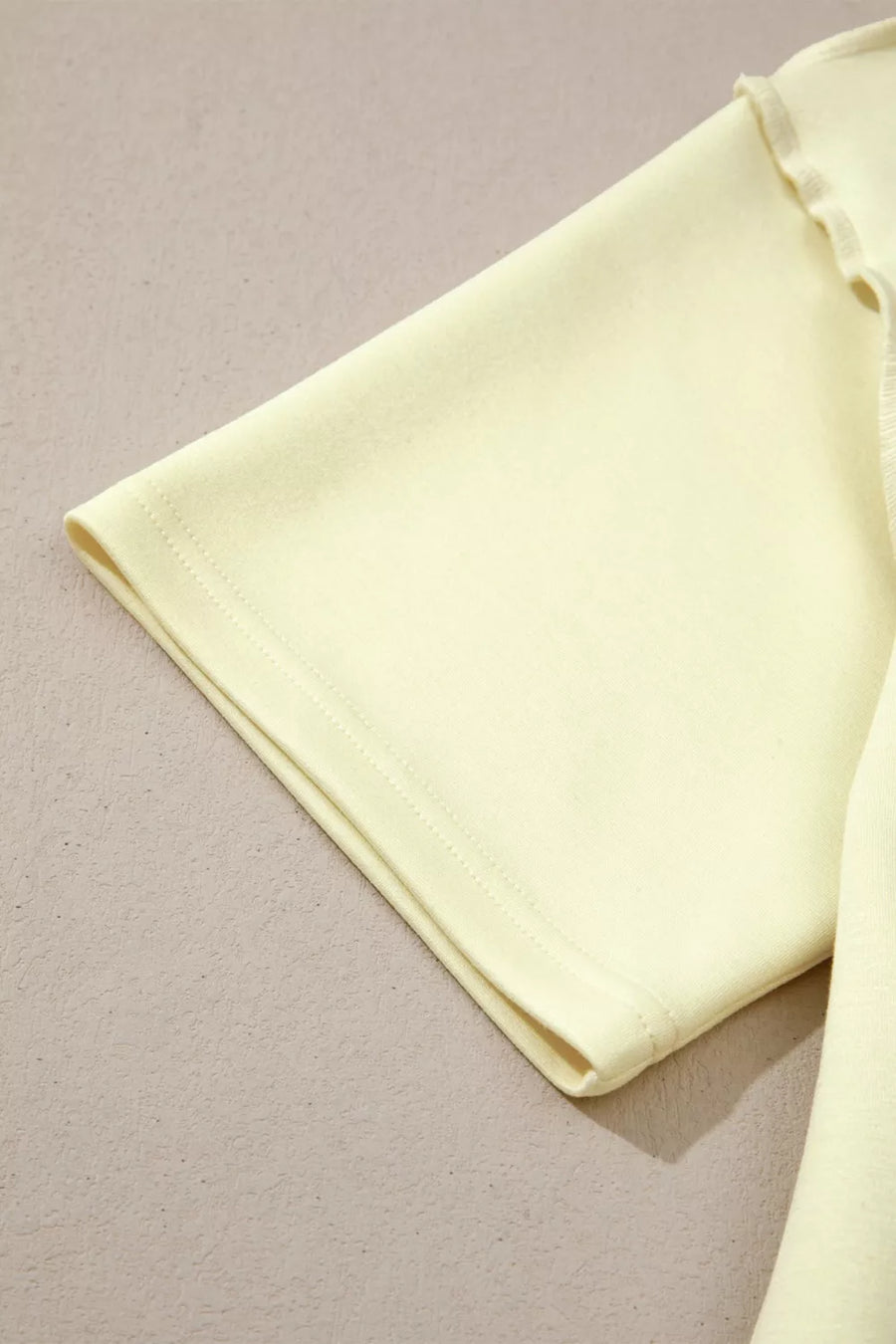 Light yellow mock neck two-piece set with dropped shoulders and lettuce trim detail.