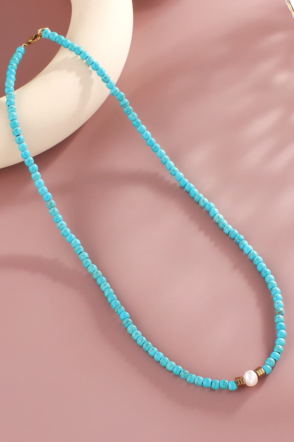 Turquoise bead necklace with pearl accent and gold clasp