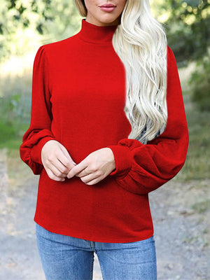 Red mock neck top with puff sleeves and button back detail