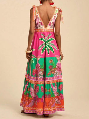 Tropical print maxi dress with tie shoulders, V-neck, and tiered skirt in pink, green, and orange.