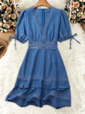 Blue lace-embellished V-neck mini dress with puff sleeves and tiered hem