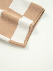 Drop shoulder sweater in camel and white checkerboard pattern with ribbed trim.