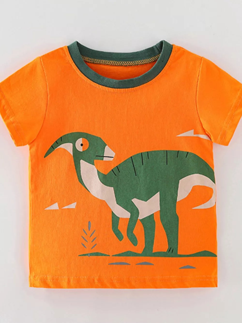 Orange t-shirt with green dinosaur graphic and contrast green neckline.