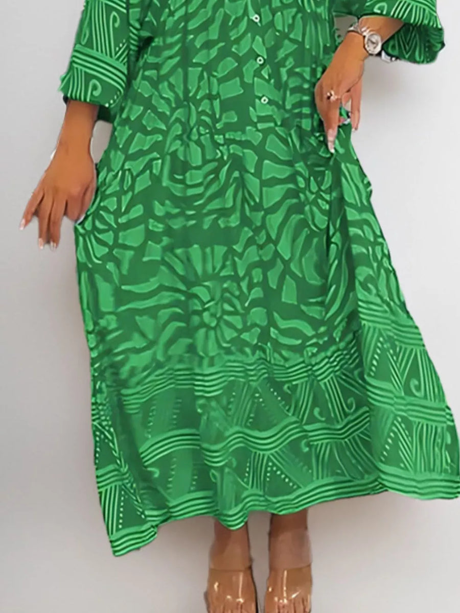 Green abstract print midi dress with 3/4 sleeves and pockets.