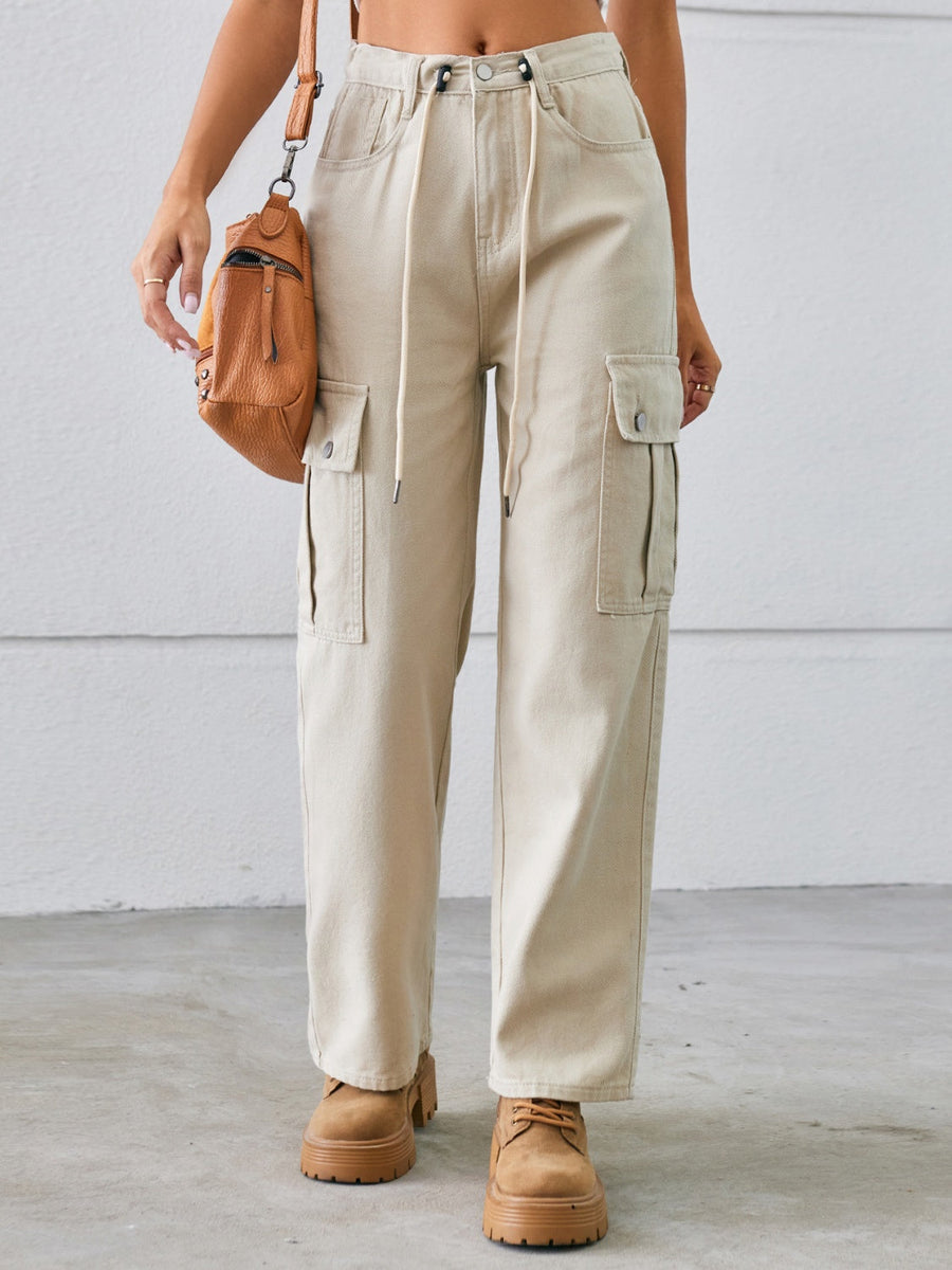 Tan drawstring cargo wide-leg denim trousers with buttoned flap pockets.