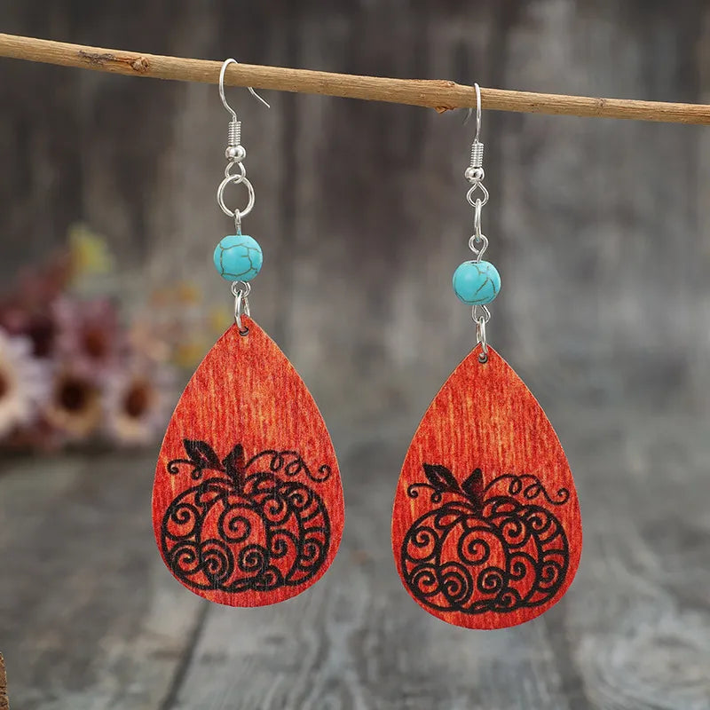 Autumnal pumpkin wood dangle earrings with turquoise beads and silver hooks.