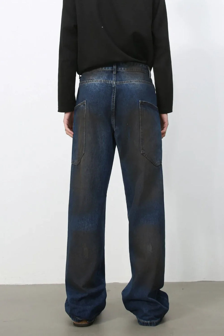 Faded panel wide-leg denim trousers in medium wash with distressed details.