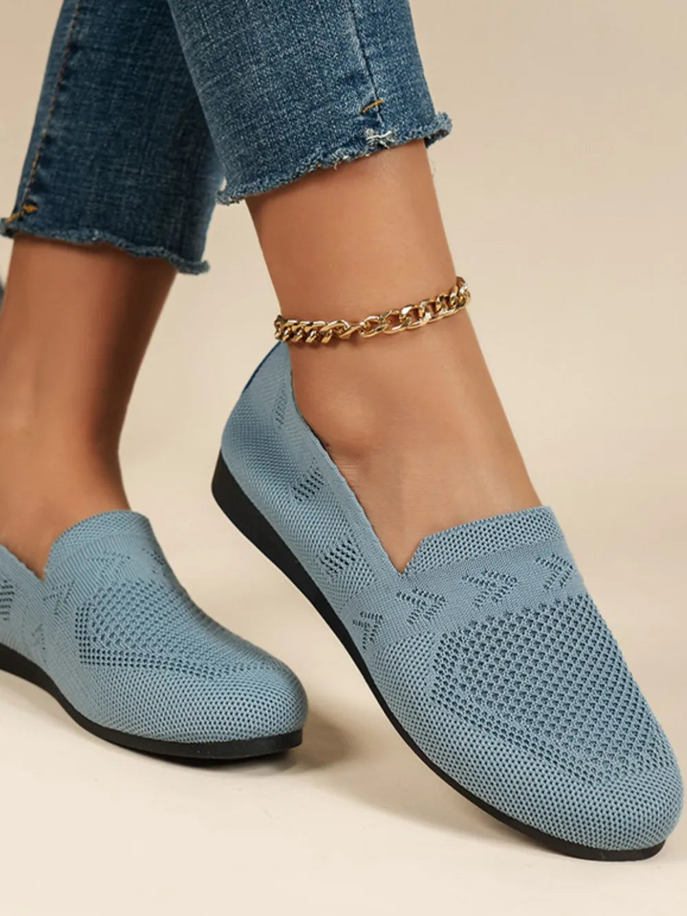 Light blue breathable knit slip-on loafers with a textured pattern and a gold anklet.