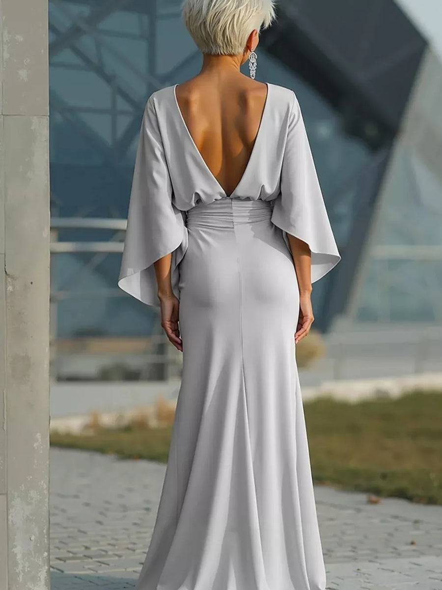 Sophisticated silver batwing sleeve maxi dress with deep V-back and cinched waist.