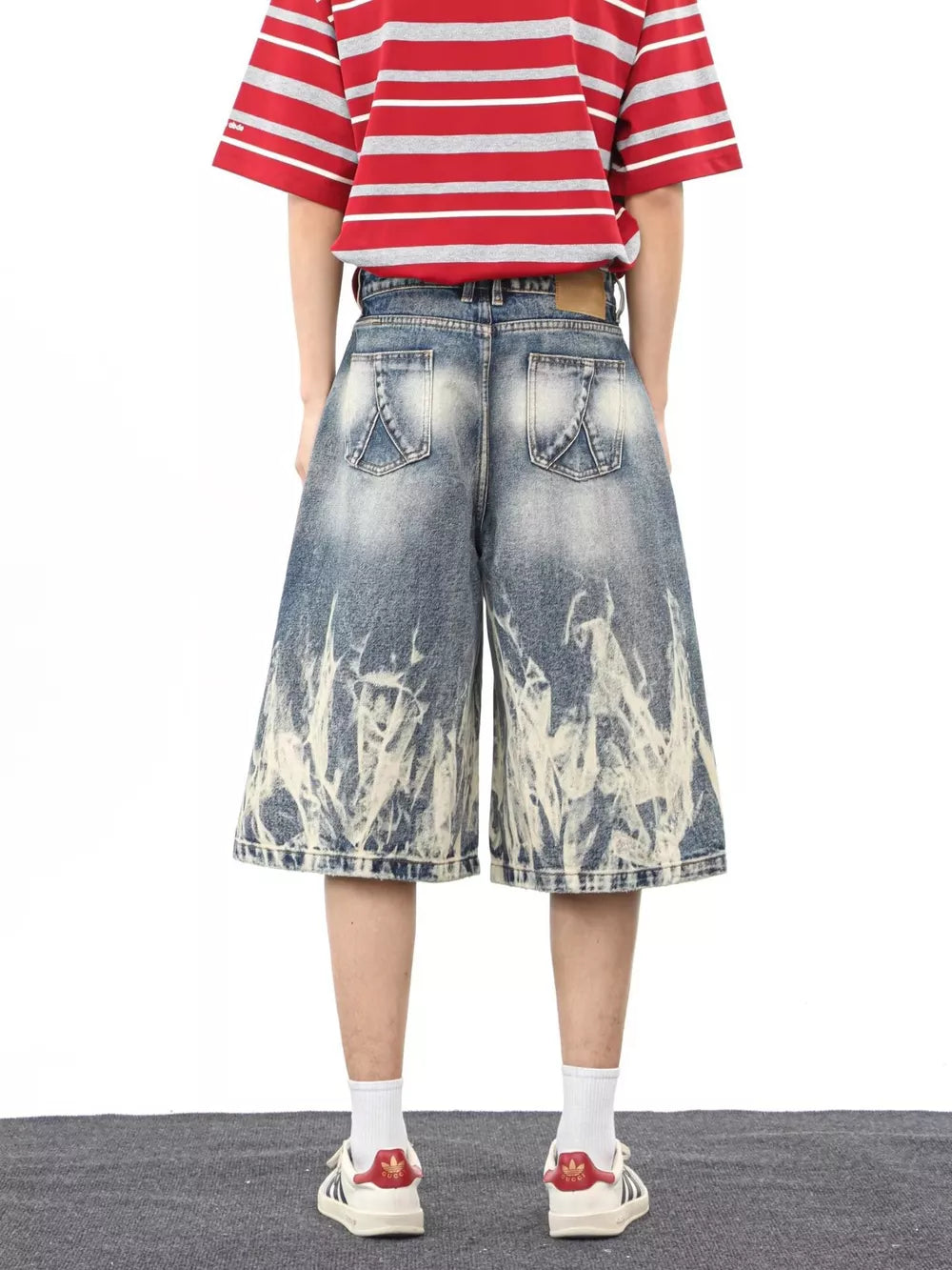 Men's wide-leg denim shorts with abstract bleach pattern and pockets