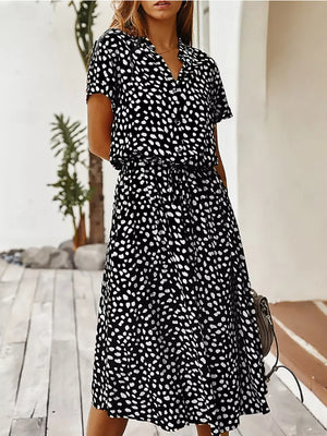 Black polka dot midi dress with drawstring waist and pockets