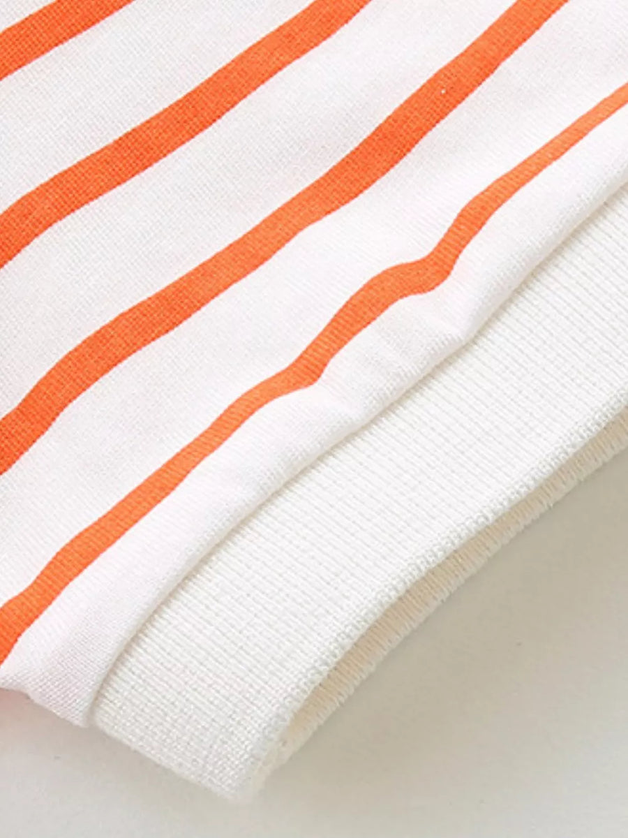 White and orange striped baby polo shirt detail with ribbed cuff