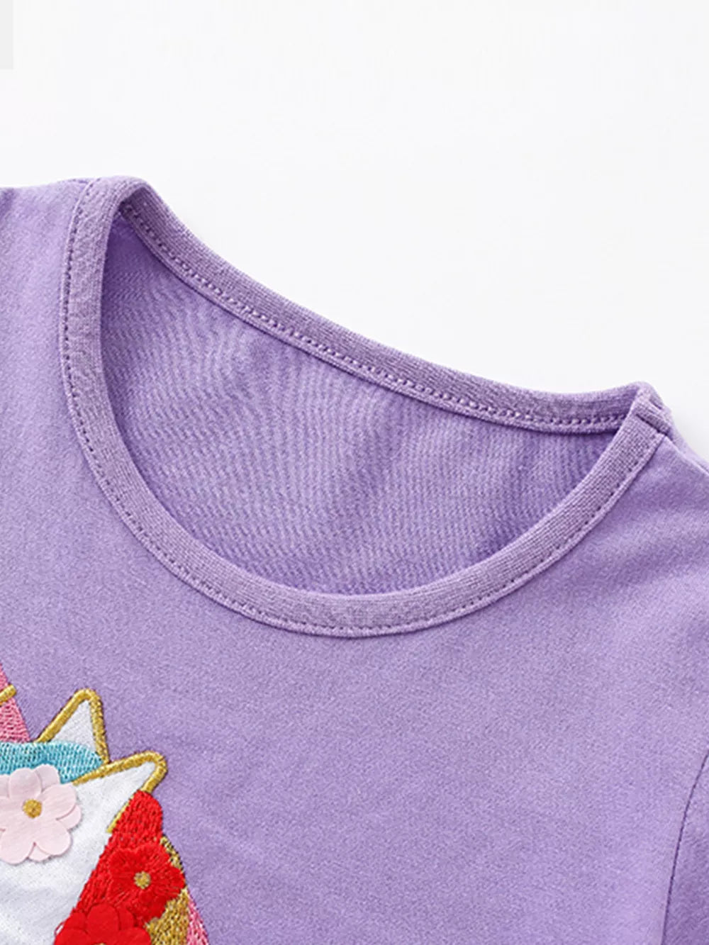 Purple cotton baby dress with unicorn embroidery and floral details.