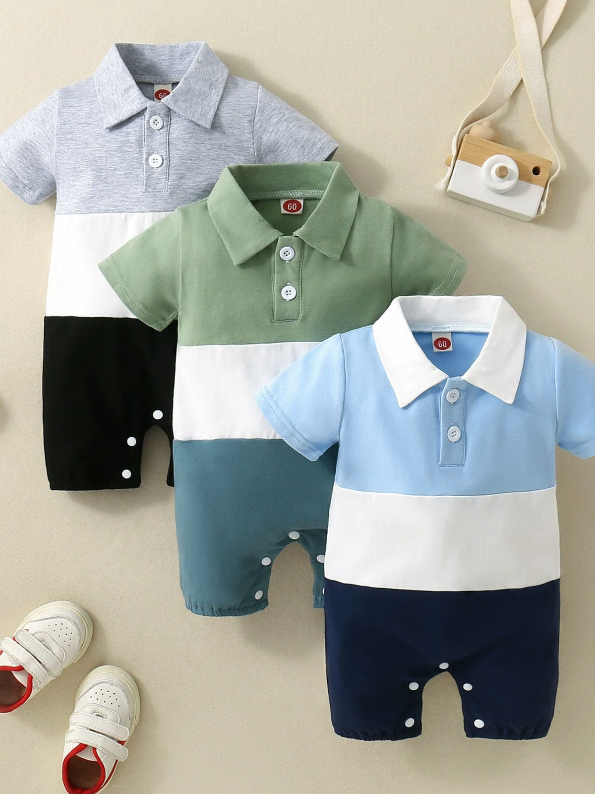Color block polo collar baby one-piece in light gray, moss green, and sky blue cotton.