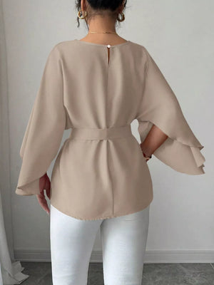 Khaki belted blouse with batwing sleeves and button closure at back neck.