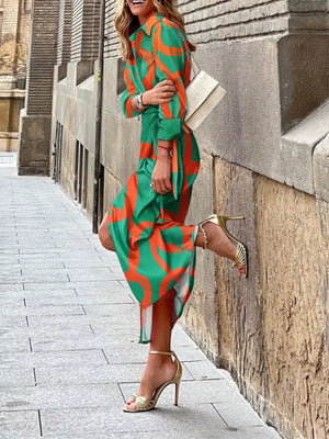 Shirt dress with abstract pattern in green and orange, 3/4 sleeves, and waist tie.